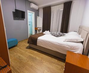 Postel nebo postele na pokoji v ubytování Olivar Hotel Tirana