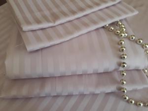 a close up of a white curtain with a pearl necklace at Comfortable Apartment in Kremenchuk