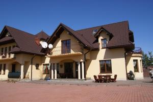 a large house with a brown roof at Agro-Gala in Rabka-Zdrój