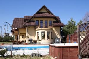 a house with a swimming pool in front of it at Agro-Gala in Rabka-Zdrój