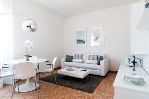 a white living room with a couch and a table at Fly by Suites Pescara in Pescara +20 photos