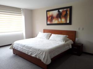 Postel nebo postele na pokoji v ubytování Misuitehotel La Carolina Quito
