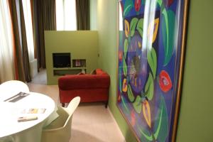 a living room with a red couch and a table at Apartaments Sant Jordi Girona 97 in Barcelona