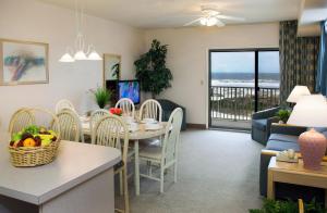 a dining room and living room with a table and chairs at Lotus Inn in Wildwood Crest