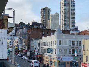 a city street with a white building and tall buildings at Royal Pacific Motor Inn in San Francisco