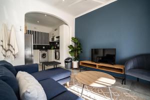 a living room with a blue couch and a table at M8 Umdloti Holiday Resort in Umdloti