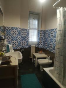 a bathroom with two sinks and two toilets at B&B Metro Salerno in Salerno