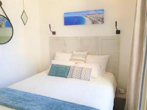 a bedroom with a white bed with two pillows on it at HYPERCENTRE/LAMARTINE APPART 211 in Nice