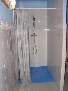 a bathroom with a shower with a shower curtain at Gîtes du Kreuzweg in Le Hohwald