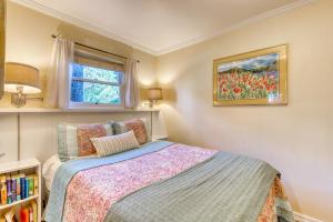 a small bedroom with a bed and a window at Woodland Cottage by the Sea in Yachats