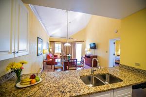 a kitchen with a sink and a plate of fruit on a counter at Pirate's Pension at Bluebeard's Castle by Capital Vacations in Pearson Gardens