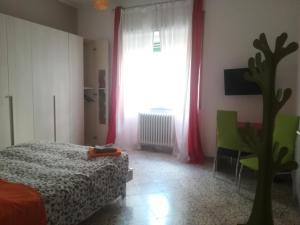 a bedroom with a bed and a window with red curtains at B&B Metro Salerno in Salerno