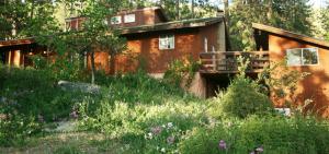 a house in the middle of a garden at Sunny Pines Cottage in Mariposa