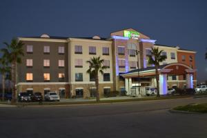 a hotel on a city street at night at Holiday Inn Express Seguin, an IHG Hotel in Seguin