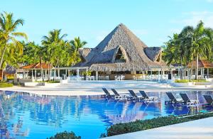 a resort with chairs and a swimming pool at Catalonia Bayahibe - All Inclusive in Bayahibe