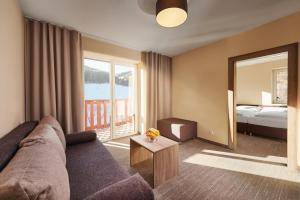 A bed or beds in a room at Hotel Studničky