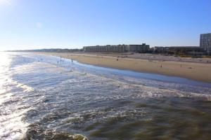 a view of a beach with people in the water at Shangri-La in Folly Beach