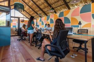 a group of people sitting at a table in an office at Socialtel Atitlan in Panajachel