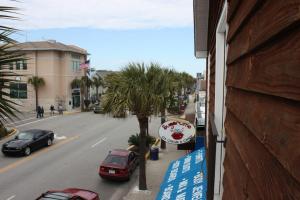 a view of a street with palm trees from a building at Shangri-La in Folly Beach