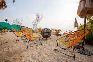 a group of chairs sitting on the beach at Socialtel Atitlan in Panajachel +45 photos