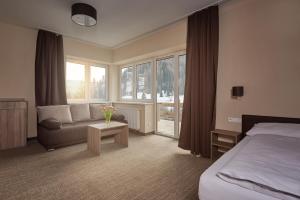 A bed or beds in a room at Hotel Studničky