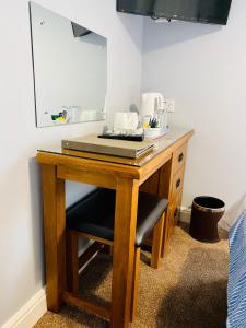 a wooden table with a sink and a mirror at Pinewood B&B in Saundersfoot