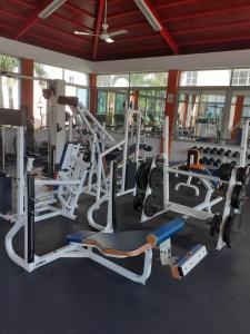 a gym with several treadmills and weights at SANTIAGO CITY in Santiago de los Caballeros