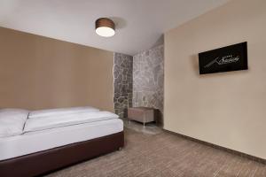 A bed or beds in a room at Hotel Studničky