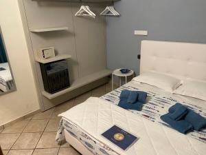 ein Schlafzimmer mit einem Bett mit zwei blauen Kissen darauf in der Unterkunft B&B ALDA in Levanto