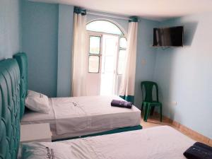 מיטה או מיטות בחדר ב-Hospedaje La Ola Azul