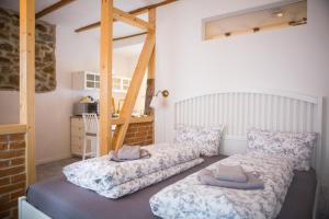 a bedroom with two beds and a ladder at ApartOne Palais-Apartments in Bautzen