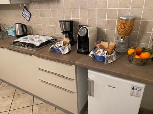 a kitchen counter with bread and a coffee maker on it at B&B ALDA in Levanto