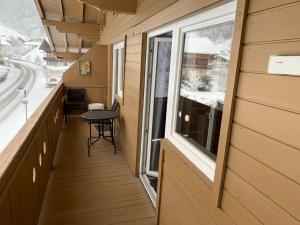 a small balcony with a table and a window at Haus Dienten Top 11 in Dienten am Hochkönig