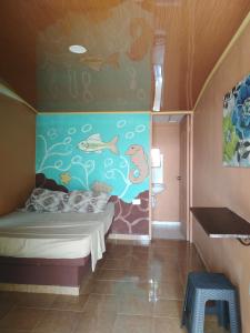 - une chambre avec une fresque murale représentant des poissons dans l'établissement Ofiuras Hostal, à Colón