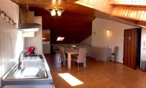 a kitchen with a sink and a table with chairs at Appartamento Edoardo centro storico Cervia in Cervia
