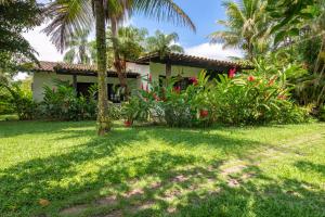 a house with palm trees and a yard at Selina Paraty in Paraty