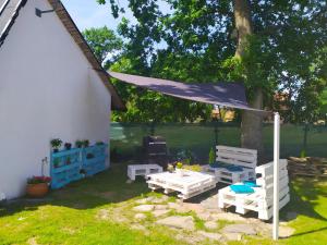 a backyard with a table and chairs and a tent at Eko Dolina Kluki in Kluki