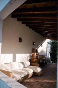 a living room with a couch on a patio at Casas da Maria - sea & countryside - Sintra in Sintra