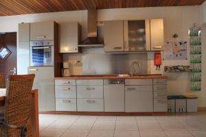 a kitchen with white cabinets and a sink at Apartment Charlotte in Neunkirchen