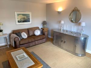 a living room with a couch and a table at Spacious 2 Bed Apartment With Off Street Parking in Bath