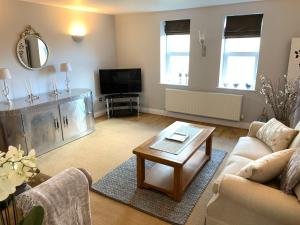 a living room with a couch and a coffee table at Spacious 2 Bed Apartment With Off Street Parking in Bath