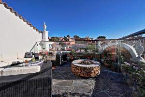 a patio with a fire pit on a balcony at On Hotel Boutique in Sucre