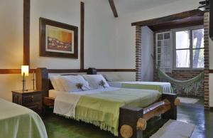 a bedroom with two beds and a window at Solar dos Ipês in Serra do Cipo +97 photos