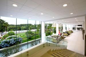 a large lobby with a large glass wall at Hotel Mediteran Plava Laguna in Poreč