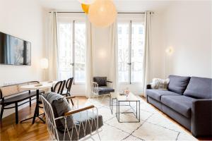 a living room with a couch and a table at Bourse Montorgueil in Paris