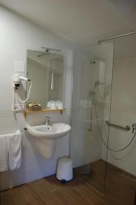 a bathroom with a sink and a glass shower at Complejo Molí de L'Hereu in Ráfales