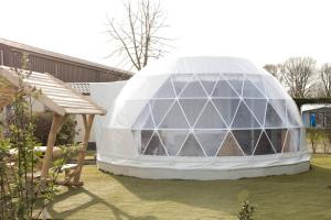 a large glass dome sitting in a yard at Costa Kabrita in Huijbergen +55 photos