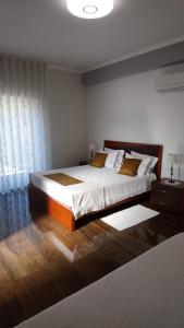 um quarto com uma cama grande e uma janela em ALojamento Costa da Banga no Gerês