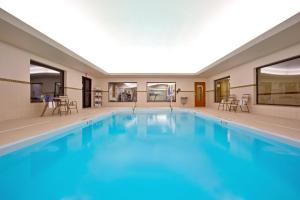 a large swimming pool with blue water at Holiday Inn Express Hotel & Suites Tipp City, an IHG Hotel in Tipp City