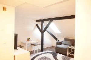a living room with a couch and a chair at Vivo Apartments Herne in Herne